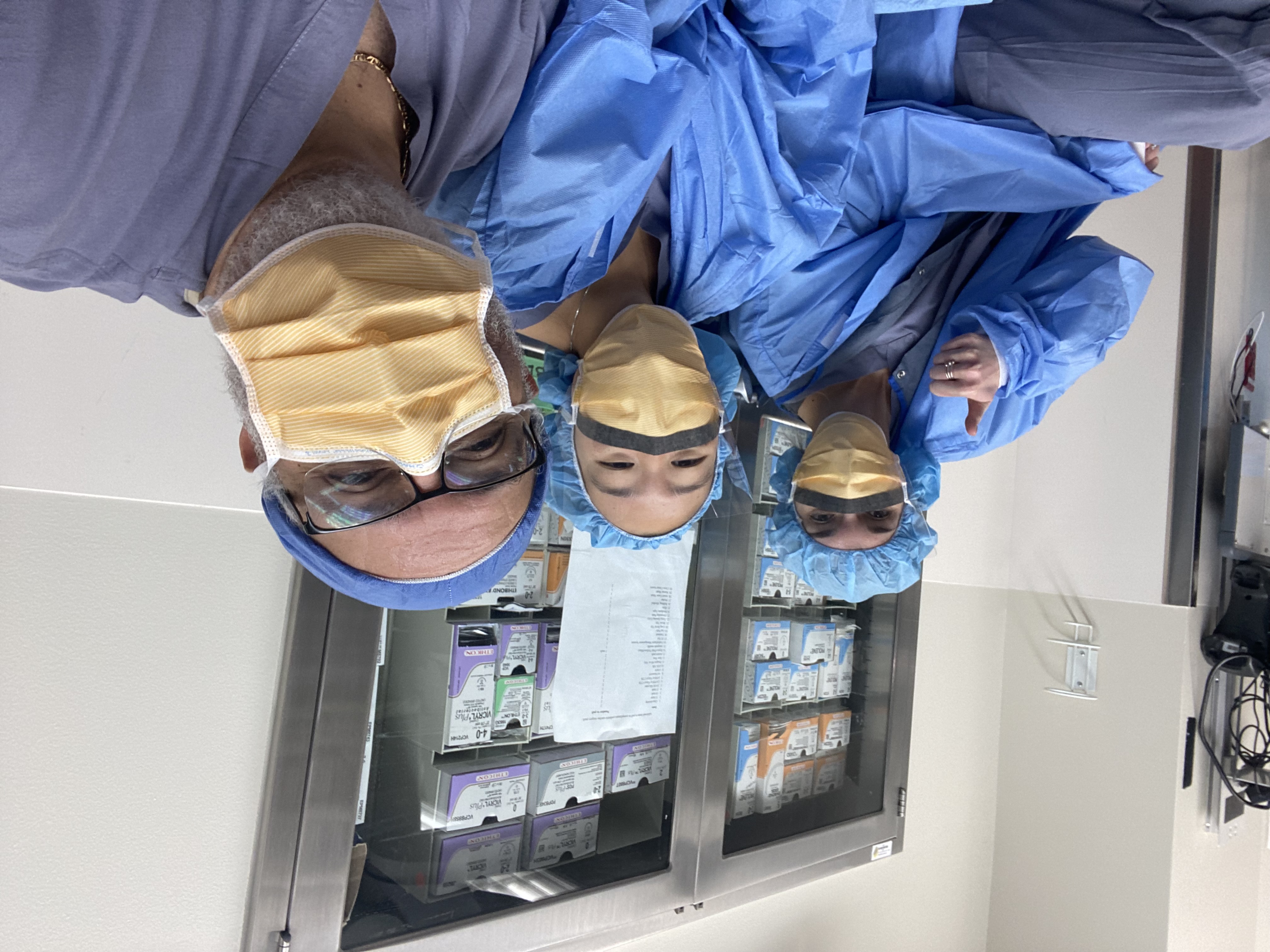 Erin Fenton and Karis Cha in the operating room with Angel Medina, AA for Cardiothoracic and Vascular Surgery